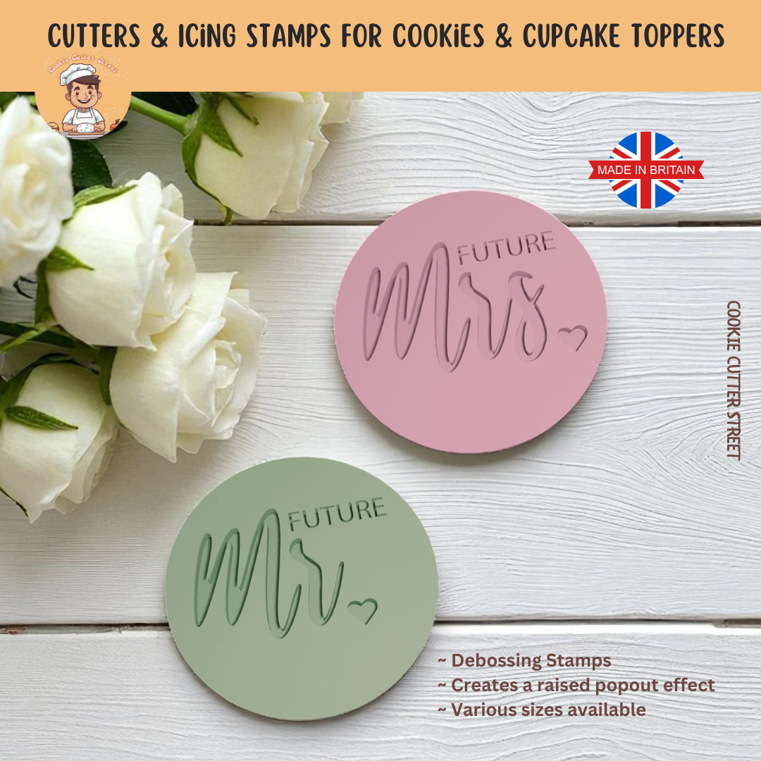 Two cookie cutters with 'FUTURE MR' and 'FUTURE MRS' text on a wooden surface with flowers.