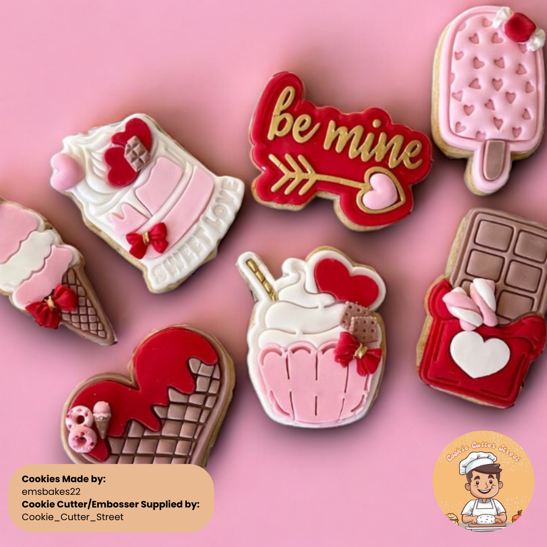 A vibrant display of Valentine’s-themed cookies on a pink background, featuring designs such as a red heart-shaped cookie with chocolate drizzle, an ice cream cone with a bow, a "Be Mine" arrow design, a cupcake topped with whipped cream, a bar of chocolate with a bow, and a popsicle with heart patterns