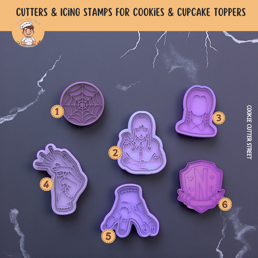 Set of purple cookie cutters with Halloween-themed designs on a dark background.