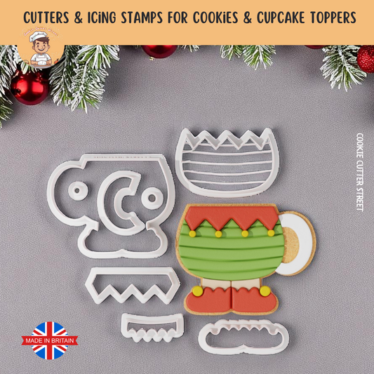 Elf Cup  cookie cutters and icing stamps for cookies and cupcake toppers on a gray background with Christmas decorations.