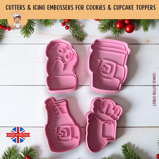 Set of pink cookie cutters with Christmas decorations on a wooden surface