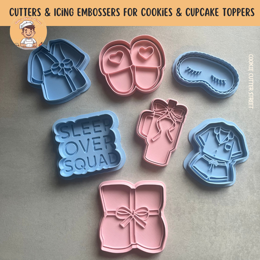 Sleepover-themed cookie cutters and icing embossers set featuring designs like slippers, pyjamas, sleep mask, drink cup and “Sleepover Squad” plaque.