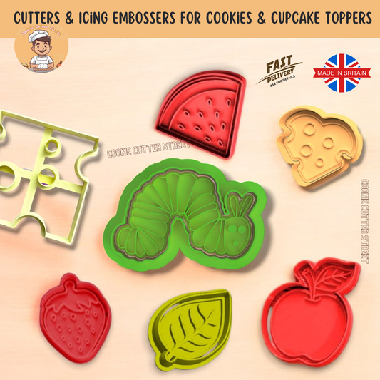 Set of Hungry Caterpillar-inspired cookie cutters and embossers, including a caterpillar character, Swiss cheese slice, heart-shaped cheese, apple, strawberry, watermelon slice, and a leaf. Cookies decorated with bright colours, some featuring small holes to mimic the caterpillar munching through