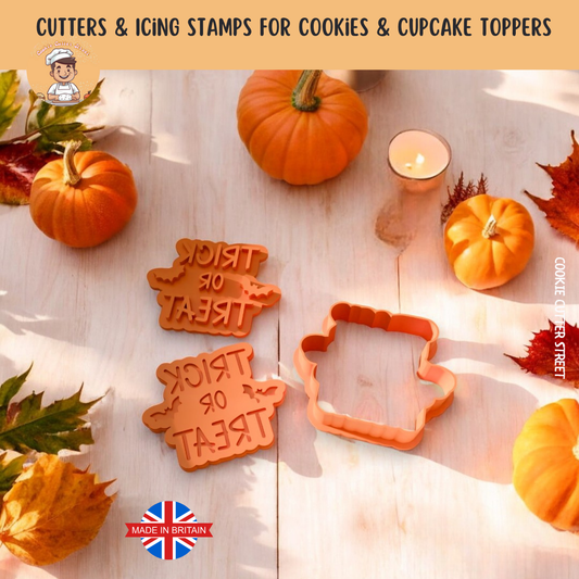 Cookie cutters with 'Treat or Treat' text and a pumpkin-shaped cutter on a wooden surface with pumpkins and leaves.