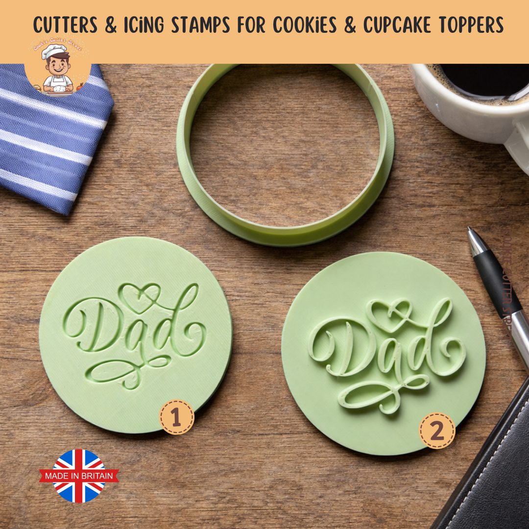 Two green cookie cutters with 'Dad' design on a wooden surface, with a cup of coffee and a pen in the background.