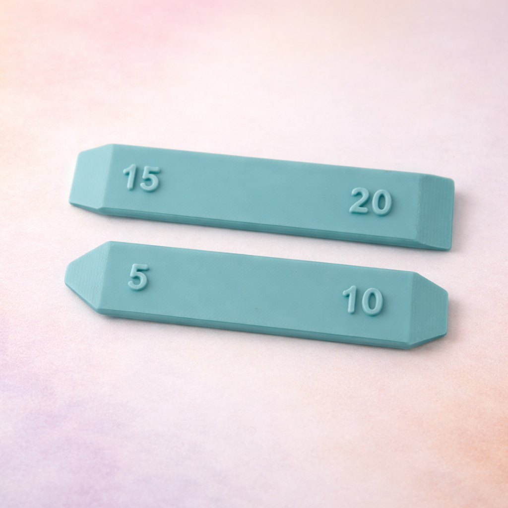 Two icing scraper tools with numbers on a gradient background